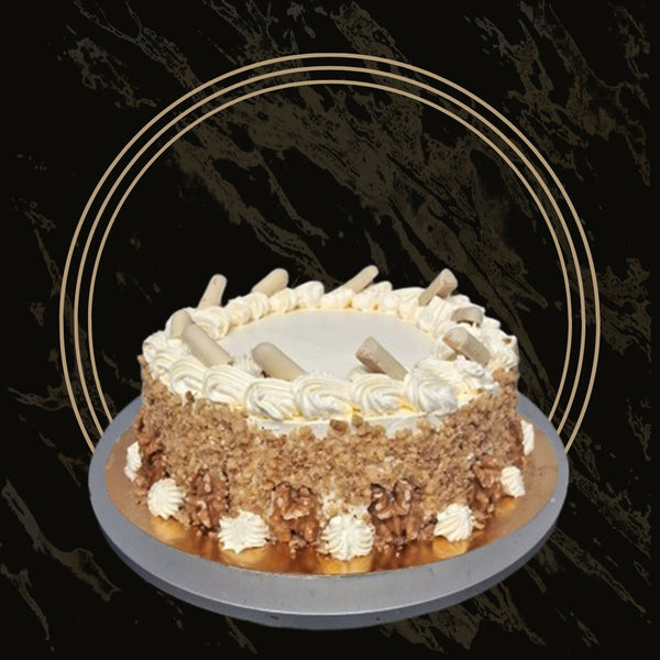 Moist slice of carrot cake with cinnamon spice and creamy topping from The Bakers Shop in Birmingham
