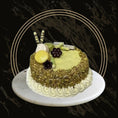 Classic pistachio cake with nut topping and creamy layers from The Bakers Shop in Birmingham